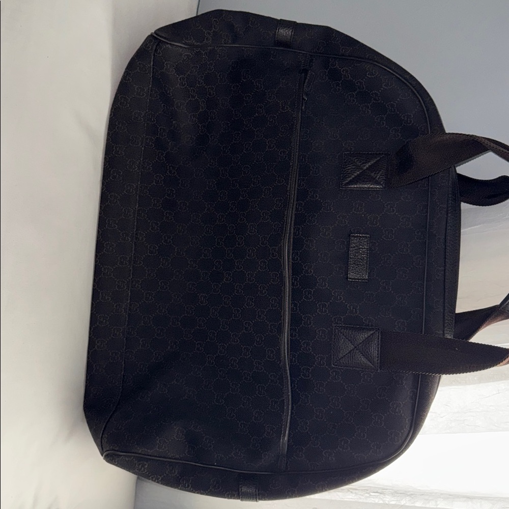 Chocolate brown GUCCI Monogram overnight canvas duffle bag.  With leather trim.